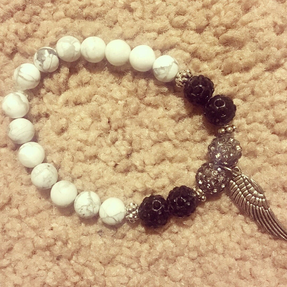 Beaded bracelet with angel wing charm